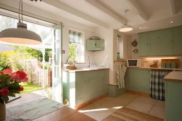 Country style kitchen with doors opening out to garden